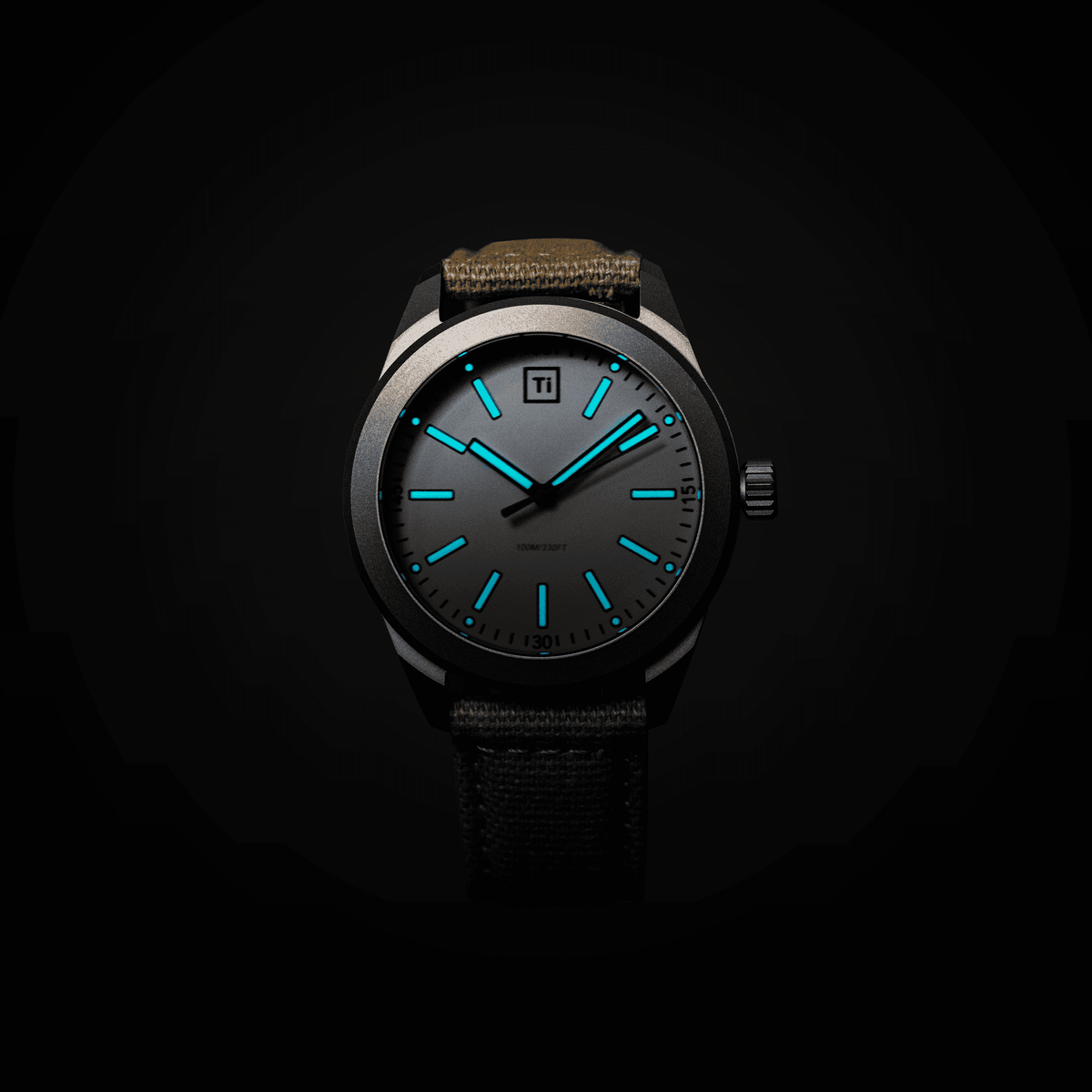 Big Idea Design LLC titanium field watch with luminous blue hands and markers dark dial titanium case canvas strap